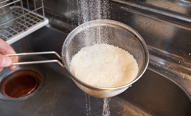 お米はざるに入れ水道水で洗う