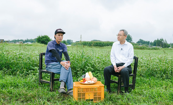 畑の真ん中で話をする井上さんと鉢木さん
