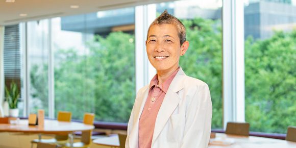 窓を背景にカメラに向かってほほえむ高尾美穂さん